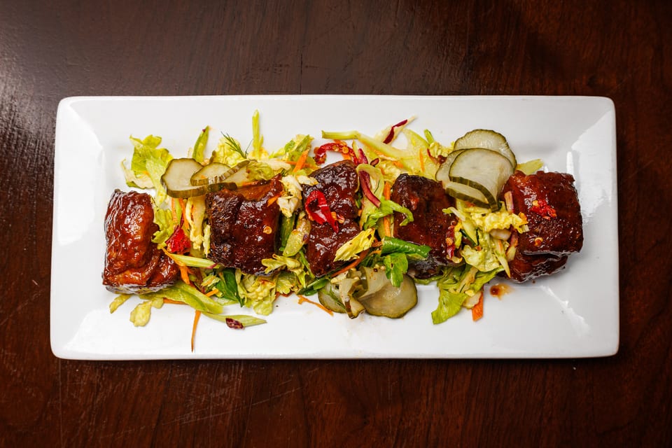 Pork belly burnt ends over slaw at The Alexander