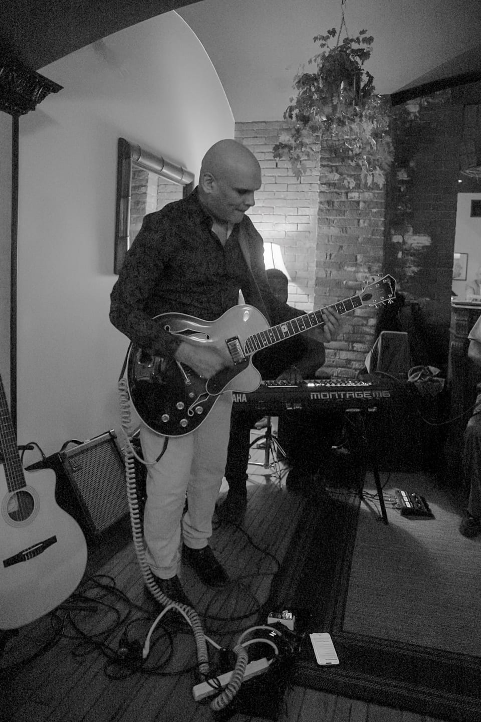 Jazz performance in the lounge — musicians in warm spotlight, intimate audience