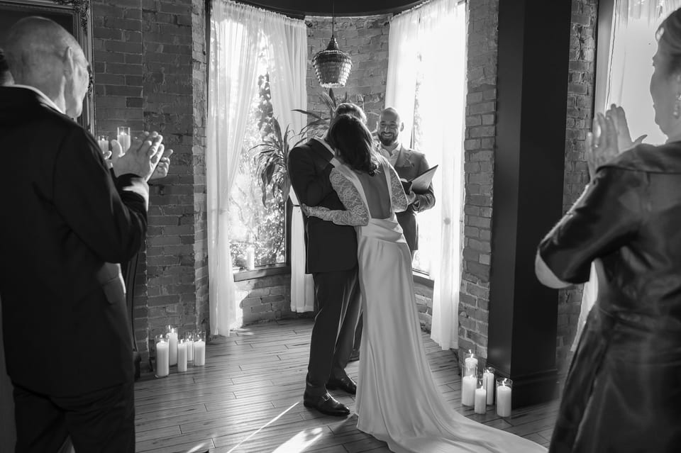Bride embracing a family member — black and white candid moment