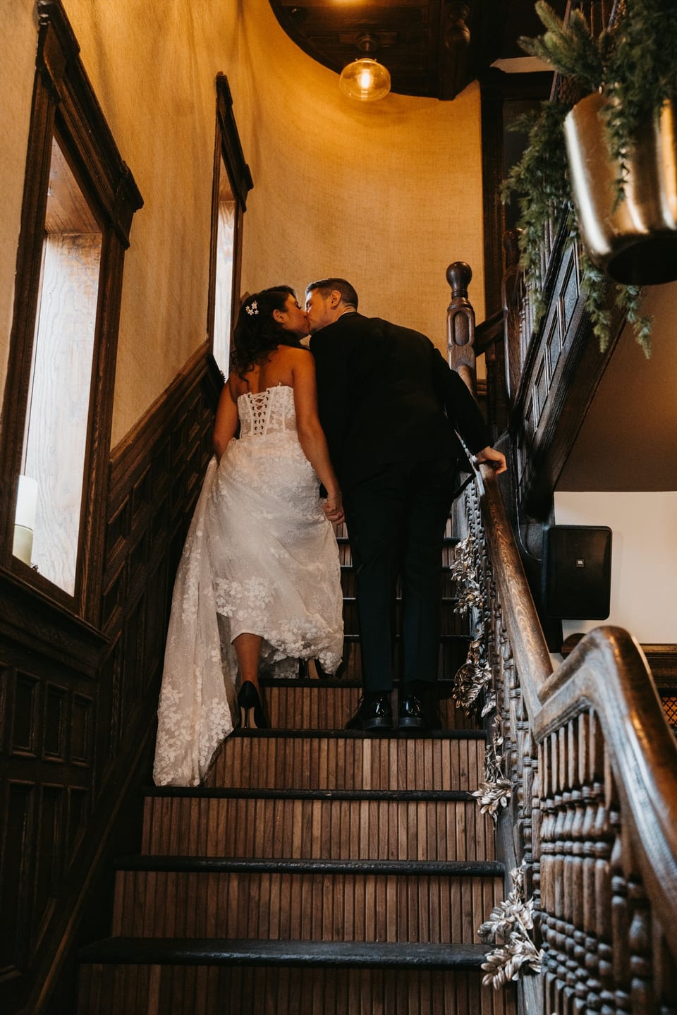 Wedding ceremony in the turret — couple at the altar with brick walls and candle line